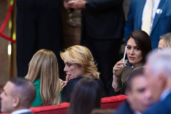 Michelle Bolsonaro ao celular no TSE e Viviane Barci de Moraes de costas, com blazer verde — Foto: Brenno Carvalho / O Globo